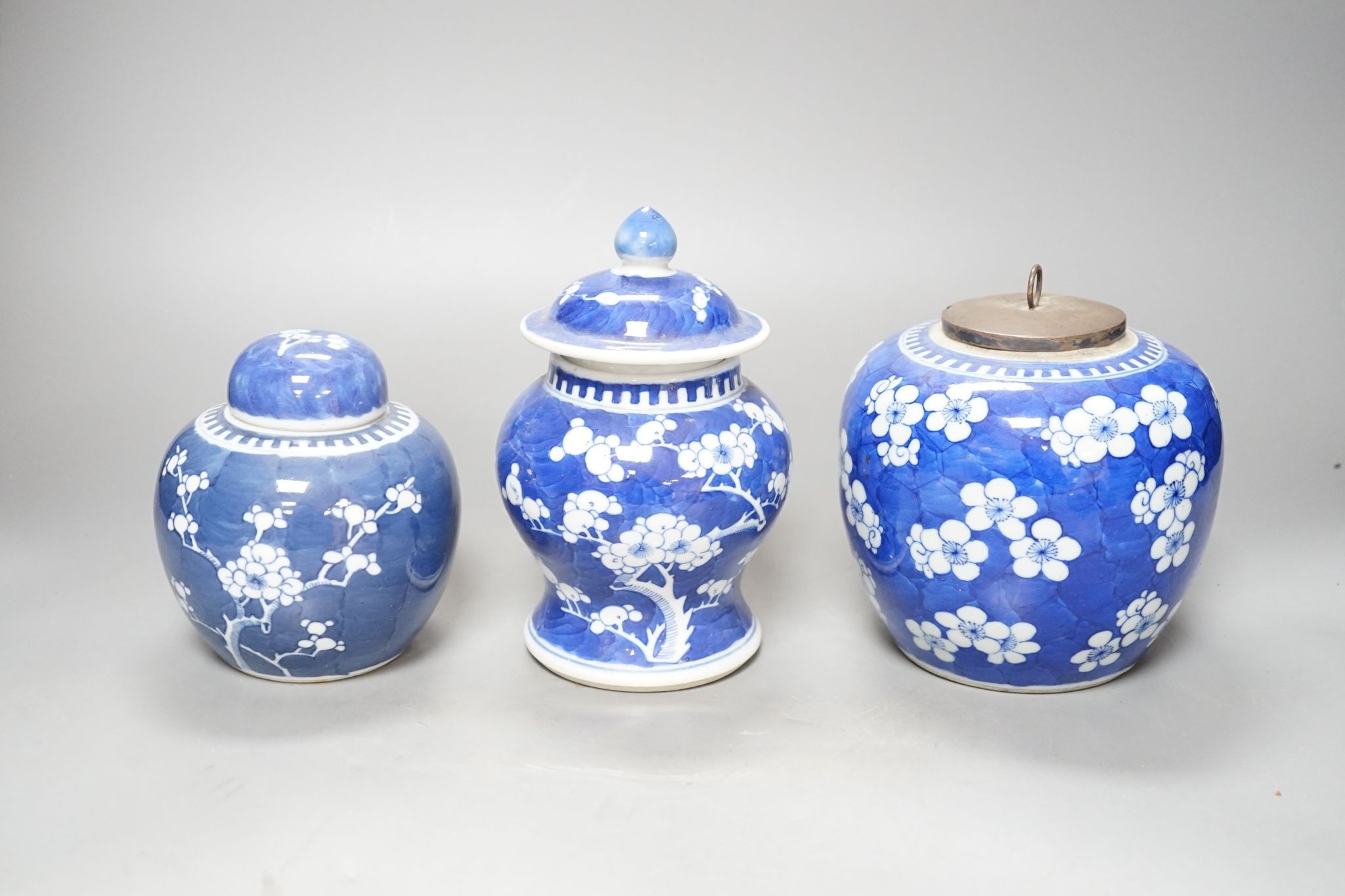 Three Chinese blue and white prunus decorated jars and covers, 19th/20th century, with four character marks 18cm
